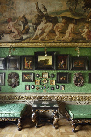 Collection of ebony-framed pictures and miniatures on the east wall of the Green Closet at Ham House, Surrey.