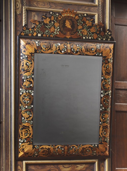 Wall mirror, 1675, of ebony, decorated with floral marquetry in various woods and ivory, at Ham House, Surrey.