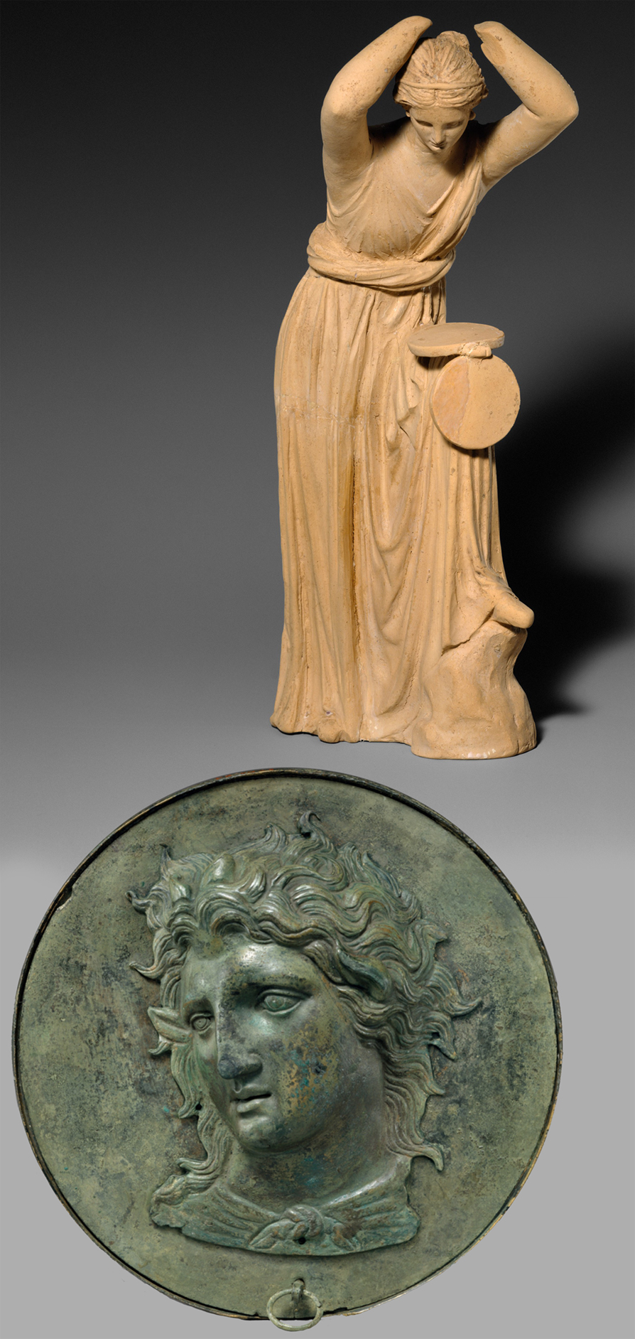 3 Statuette looking into open speculum case C3rdto2nd BC Met Mus NY